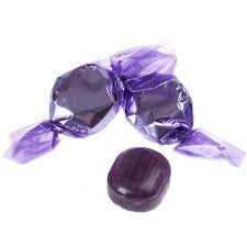 Colorful grape-flavored candy from Flavour World SA in vibrant purple packaging, showcasing sweet, chewy grape candies.