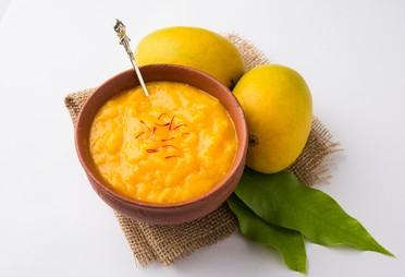 CBE Mango Pulp by Flavour World SA, showing fresh, smooth mango pulp in a clear container.