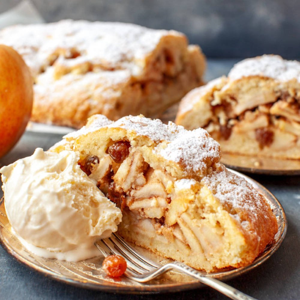 Slice of SSA Apple Strudel by Flavour World SA with flaky pastry and apple filling on a white plate.
