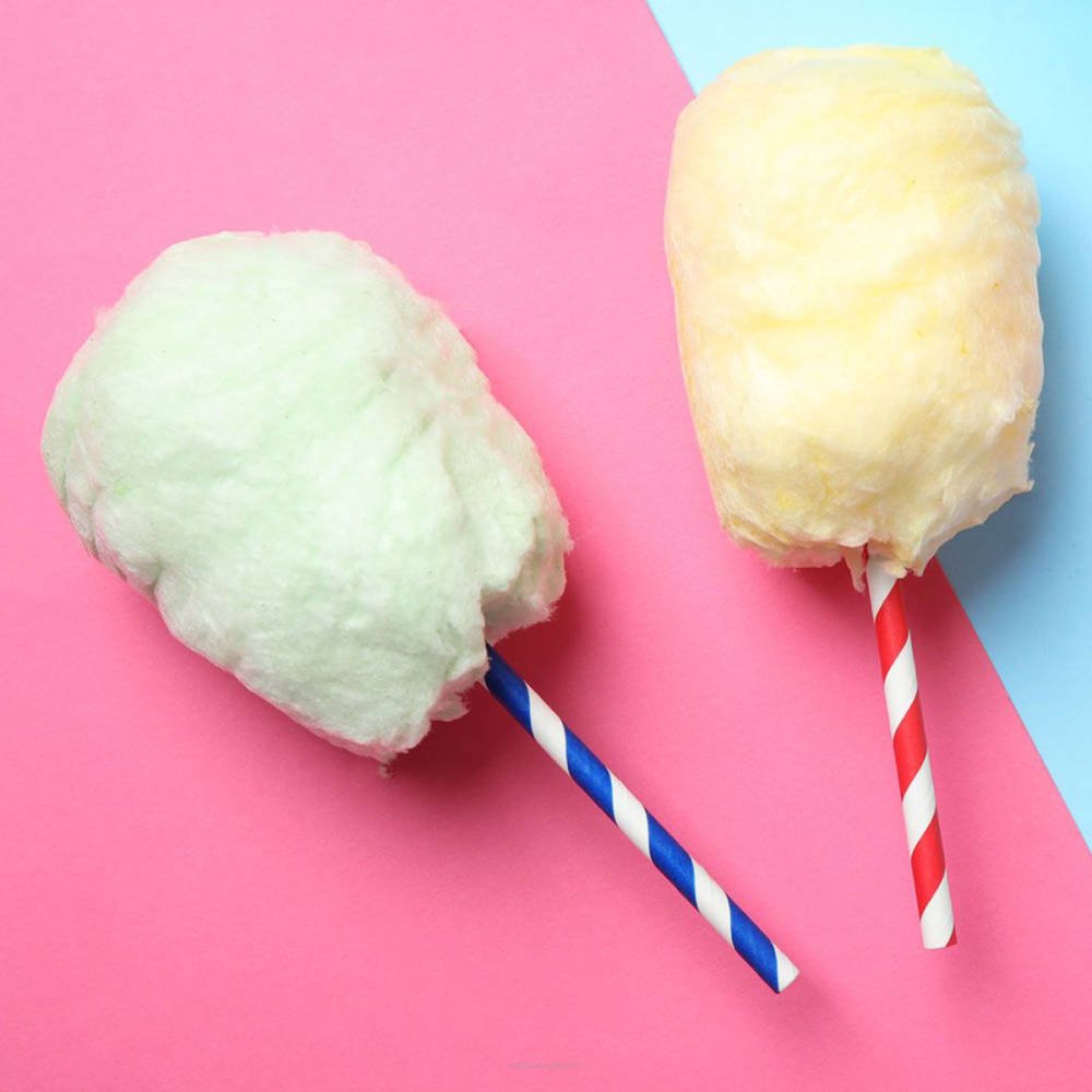 Colorful candy floss from Flavour World SA, showcasing fluffy pink and white spun sugar on a stick.