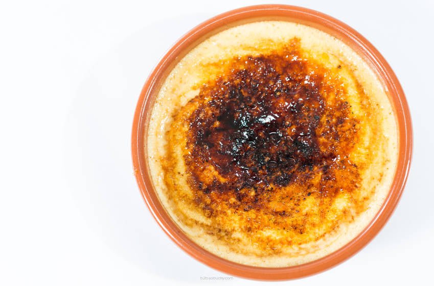 Creamy Flavour World SA Creme Brule dessert with caramelized sugar topping in a glass ramekin.