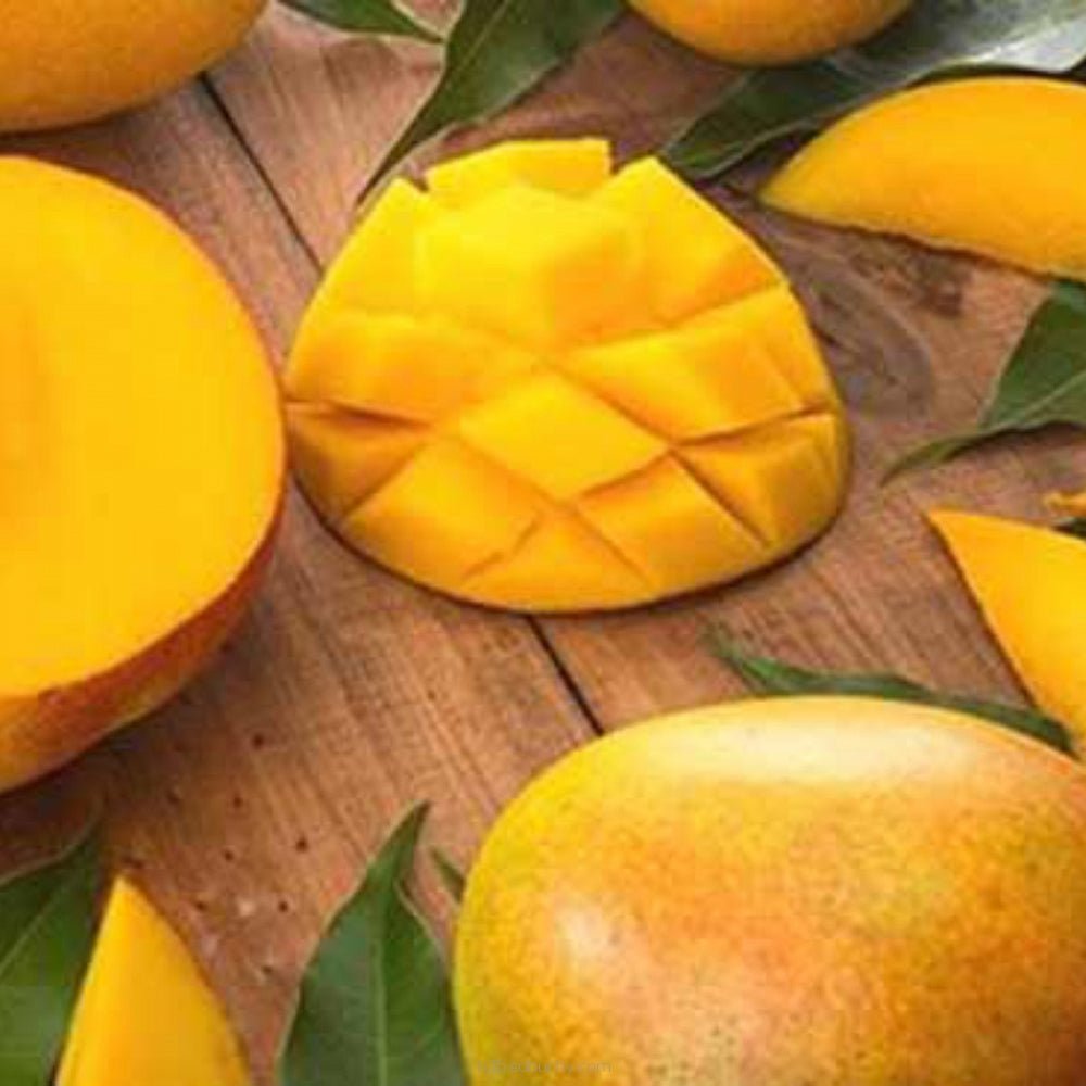 Fresh Malaysian mango from Flavour World SA, showing ripe, vibrant orange flesh and smooth green skin.