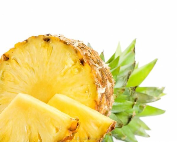 Fresh ripe pineapple from Flavour World SA, showing vibrant yellow flesh and spiky green leaves.