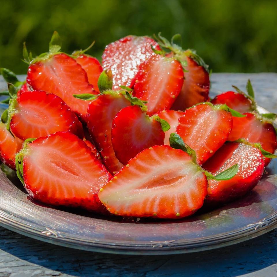 Fresh ripe strawberry from Flavour World SA, showcasing vibrant red color and natural texture.